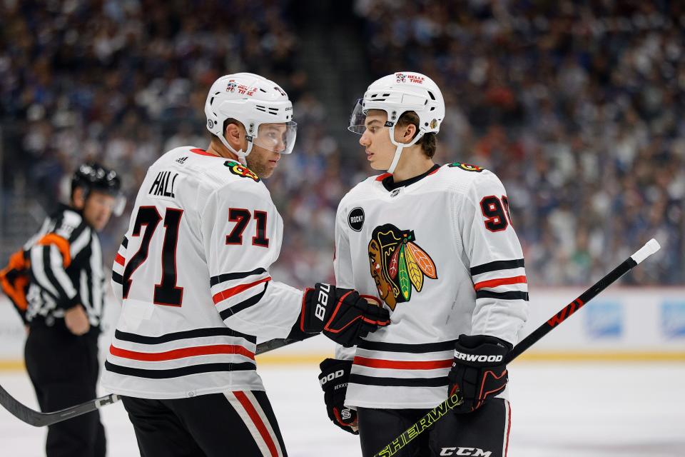 Chicago Blackhawks left wing Taylor Hall (71) talks with center Connor Bedard (98) during an October game.