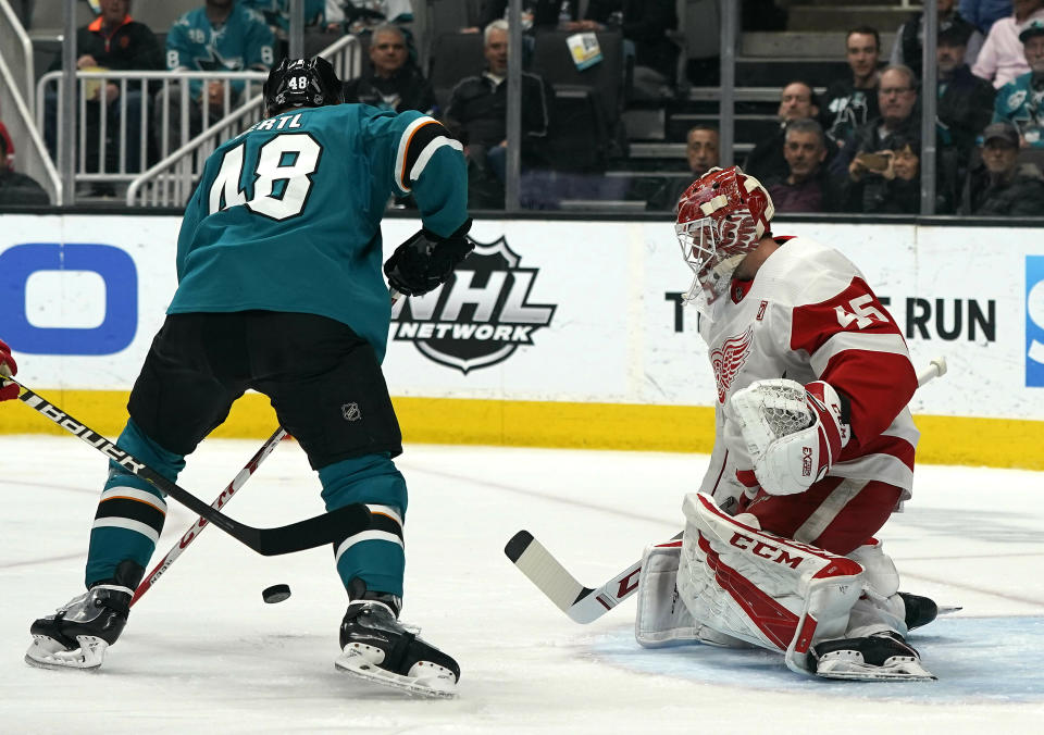 Detroit Red Wings goaltender Jimmy Howard (35) makes a save against San Jose Sharks center Tomas Hertl (48) during the first period of an NHL hockey game Monday, March 25, 2019, in San Jose, Calif. (AP Photo/Tony Avelar)