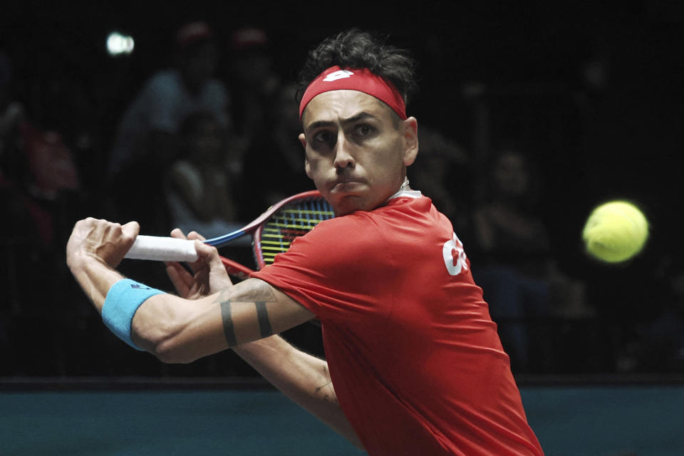 Chile's Alejandro Tabilo returns the ball to Canada's Alexis Galarneau during the men's single Davis Cup group A tennis match between Chile and Canada, in Bologna, Saturday Sept. 16, 2023. (Michele Nucci/LaPresse via AP)