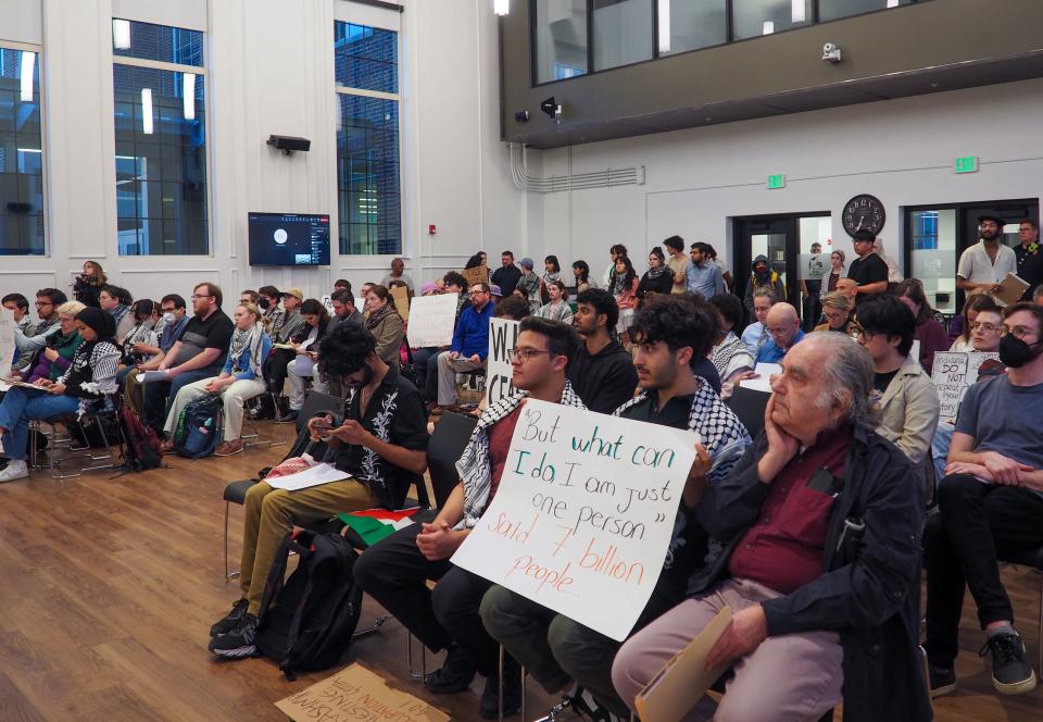 Pro-Palestinian protesters hold signs calling for the West Lafayette City Council to approve a resolution that supports a ceasefire in the Middle East, at West Lafayette's March City Council meeting, on Monday, March 4, 2024, in West Lafayette, Ind.