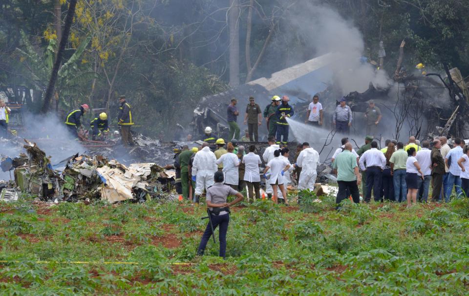 <p>Picture taken at the scene after a Cubana de Aviacion aircraft crashed after taking off from Havana’s Jose Marti airport on May 18, 2018. – A Cuban state airways passenger plane with 104 passengers on board crashed on shortly after taking off from Havana’s airport, state media reported. The Boeing 737 operated by Cubana de Aviacion crashed “near the international airport,” state agency Prensa Latina reported. Airport sources said the jetliner was heading from the capital to the eastern city of Holguin. (Photo: Adalberto Roque/AFP/Getty Images) </p>