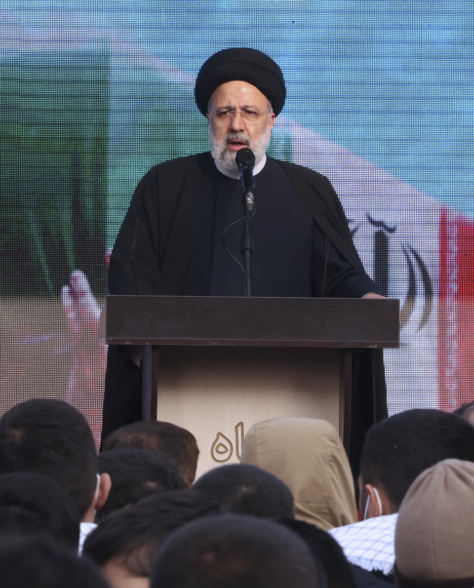 Iranian President Ebrahim Raisi speaks during a funeral procession for a group of unknown Iranian soldiers who were killed during the 1980-88 Iran-Iraq war, whose remains were recently recovered in the battlefields, in Tehran, Iran, Tuesday, Dec. 27, 2022. (AP Photo/Vahid Salemi)