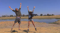 <p>The pair jumps for joy on their trip.</p>