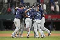 Seattle Mariners' Jorge Polanco (7), J.P. Crawford (3), Ty France (23) and others celebrate the team's 4-0 win in a baseball game against the Texas Rangers in Arlington, Texas, Tuesday, April 23, 2024. (AP Photo/Tony Gutierrez)