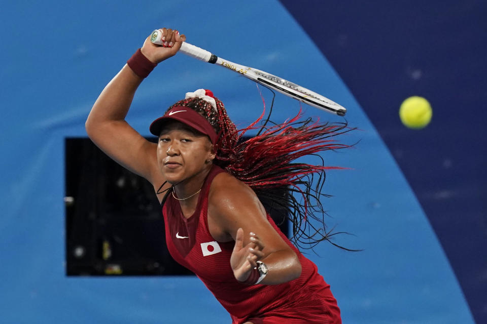 Naomi Osaka, of Japan, plays Marketa Vondrousova, of the Czech Republic, during the third round of the tennis competition at the 2020 Summer Olympics, Tuesday, July 27, 2021, in Tokyo, Japan. (AP Photo/Seth Wenig)