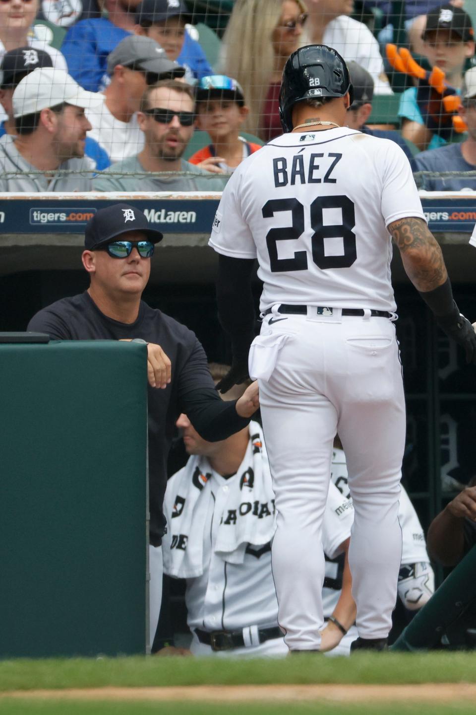 Detroit Tigers shortstop Javier Baez (28) receives congratulations from manager A.J. Hinch (14) after scoring in the second inning against the Toronto Blue Jays at Comerica Park in Detroit, Michigan on July 9, 2023.