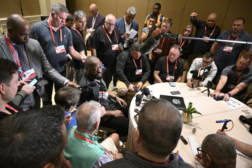 Pittsburgh Steelers head coach Mike Tomlin, center, talks with reporters during an AFC coaches availability at the NFL owners meetings, Monday, March 25, 2024, in Orlando, Fla. (AP Photo/Phelan M. Ebenhack)
