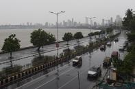 Commuters drive along Marine Drive as rain falls in Mumbai on June 3, 2020. (Photo by PUNIT PARANJPE/AFP via Getty Images)