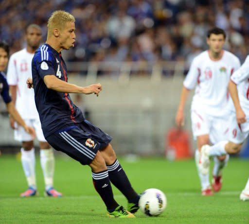 Japan's midfielder Keisuke Honda (C) kicks the ball in a penalty kick to score the team's 5th goal during their 2014 Football World Cup Asian qualifiers match against Jordan. Japan won 6-0