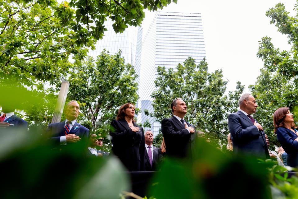 New York City mayor Eric Adams, former New York City mayor Michael Bloomberg, Vice President Kamala Harris and her husband Doug Emhoff, Senate Majority Leader Chuck Schumer and New York Governor Kathy Hochul stand for the national anthem at the ceremony to commemorate the 21st anniversary of the Sept. 11 terrorist attacks, Sunday, Sept. 11, 2022, at the National September 11 Memorial & Museum in New York.