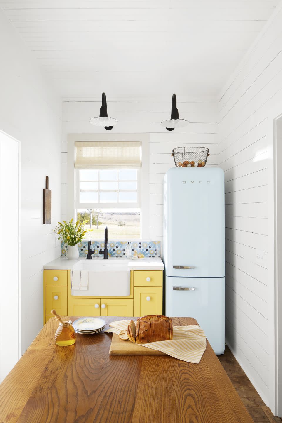 tiny kitchen with yellow cabinetry