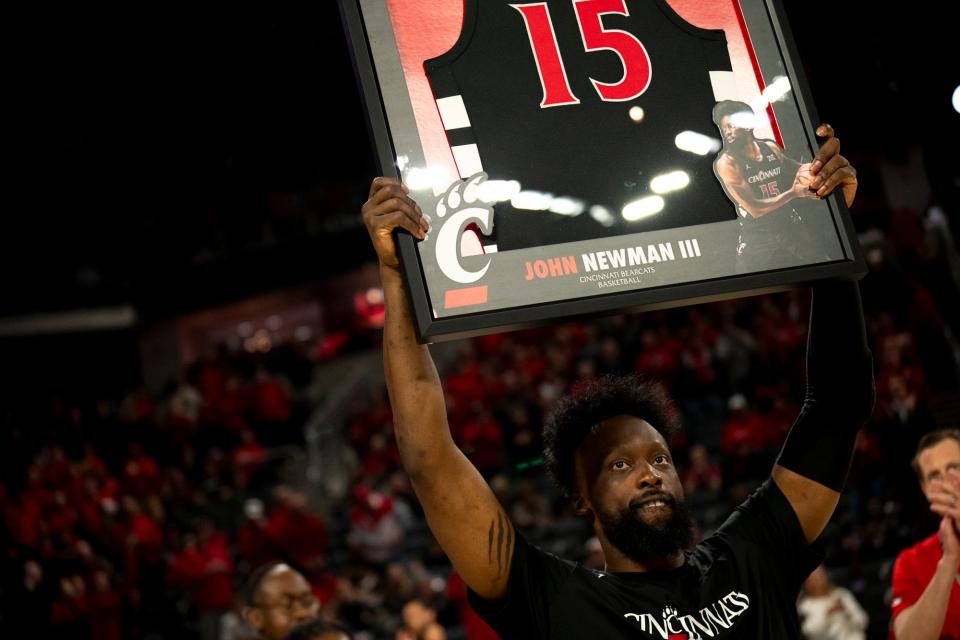 Cincinnati Bearcats forward John Newman III (15) holds up his jersey after being honored in a senior day ceremony before UC's 92-56 victory over West Virginia March 9.