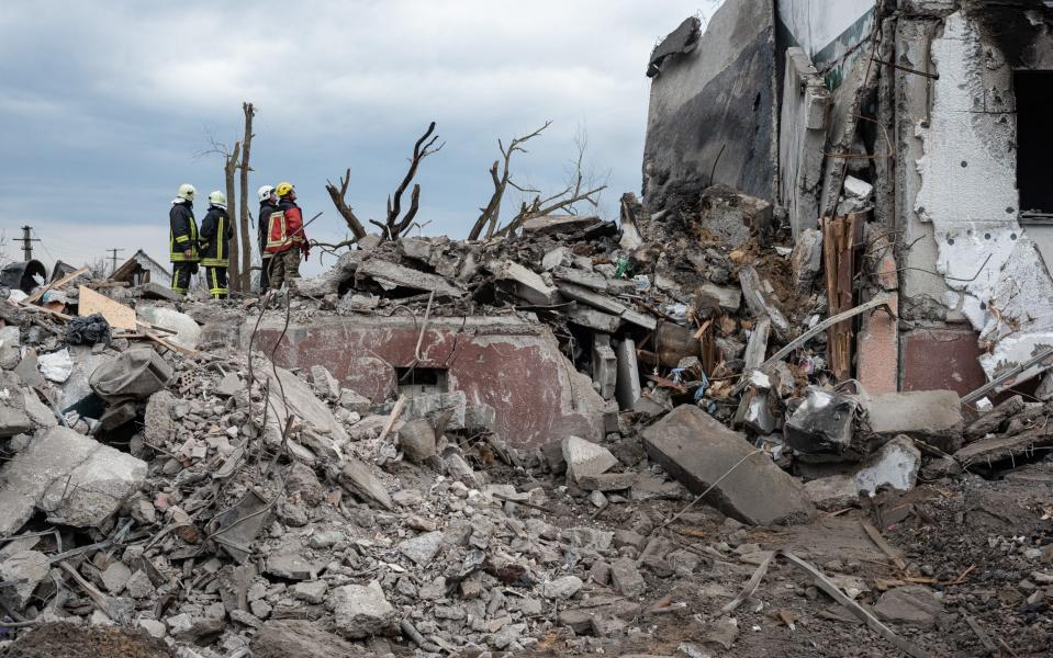 Rescue workers watch their colleague pulling bodies from the rubble on April 9, 2022 in Borodianka, Ukraine.  - Alexey Furman/Getty Images Europe