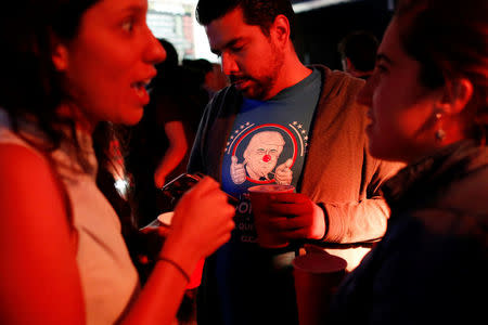 A reveler wearing a t-shirt with an image of Republican presidential nominee Donald Trump attends a Mexican brewery booze-up in Mexico City, Mexico October 20, 2016. REUTERS/Carlos Jasso