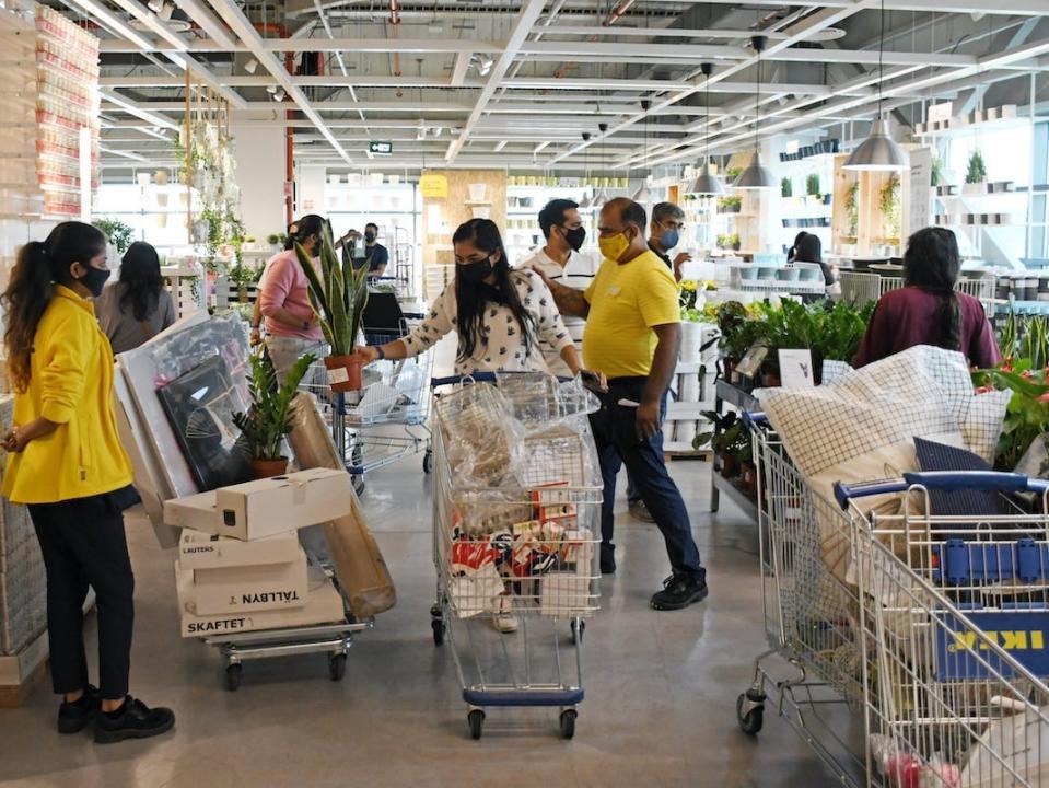 Ikea customers push carts teeming with Ikea products.