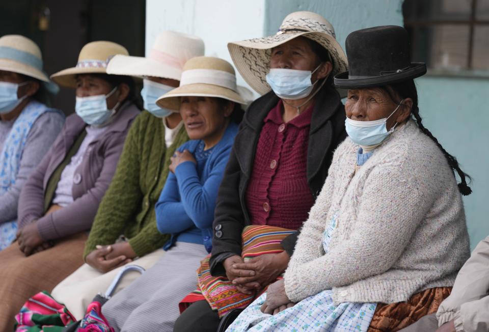 Residents attend a community meeting to discuss if they will get the Sinopharm COVID-19 vaccine, during a vaccine campaign set up at a local school in Mijane, Peru, Thursday, Oct. 28, 2021. While more than 55% of Peruvians have gotten at least one shot of COVID-19 vaccines, only about 25% of people in Indigenous areas have been vaccinated. (AP Photo/Martin Mejia)