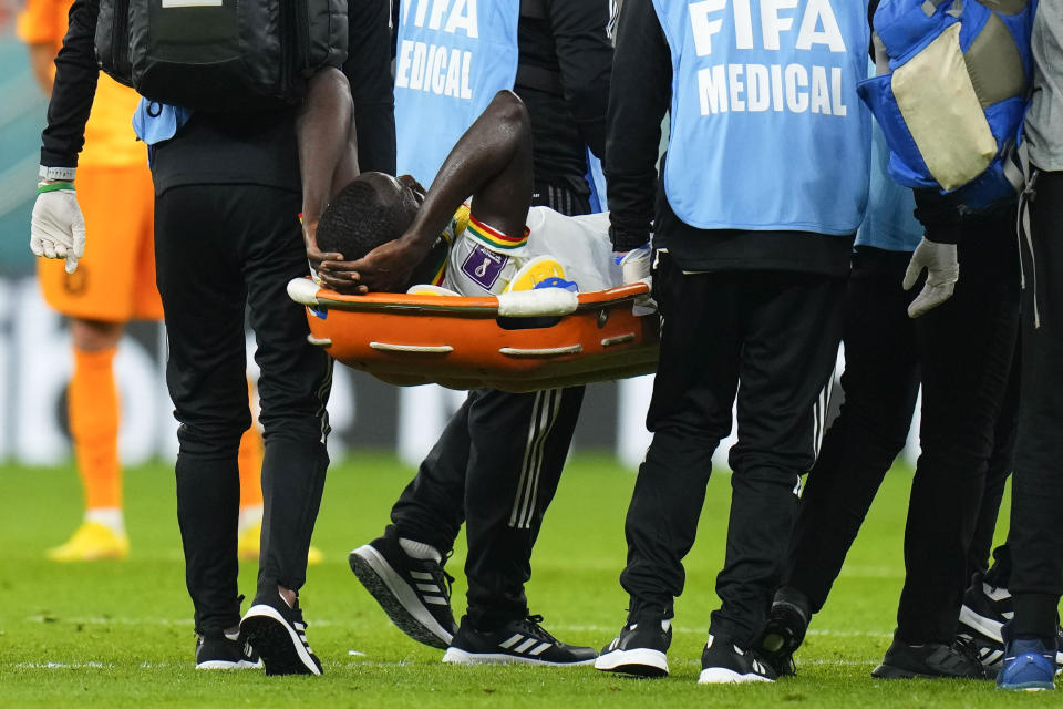 Senegal's Cheikhou Kouyate is taken from the field on a stretcher during the World Cup, group A soccer match between Senegal and Netherlands at the Al Thumama Stadium in Doha, Qatar, Monday, Nov. 21, 2022. (AP Photo/Petr David Josek)