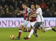 <p>West Ham United’s Manuel Lanzini, left, fights for the ball with Manchester United’s Jesse Lingard during their English Premier League soccer match between West Ham United and Manchester United at the London stadium, in London Monday, Jan. 2, 2017. (AP Photo/Alastair Grant) </p>