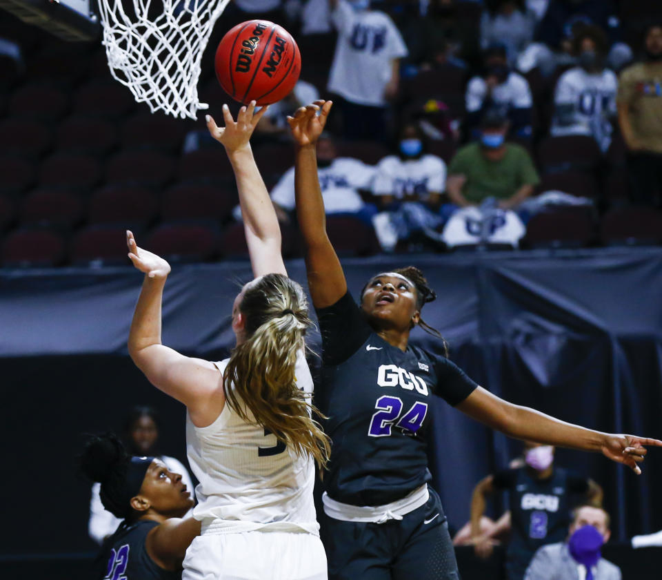 Grand Canyon's Tiarra Brown (24) and California Baptist's Caitlyn Harper (34) battle for control of the ball during the first half of an NCAA college basketball game for the championship of the Western Athletic Conference women's tournament Saturday, March 13, 2021, in Las Vegas. (AP Photo/Chase Stevens)