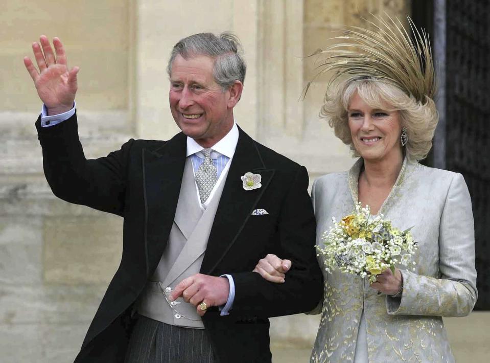 FILE - Britain's Prince Charles with his new wife Camilla, Duchess of Cornwall acknowledges the crowd following a Service of Prayer and Dedication at St. George's Chapel at Windsor Castle, Saturday, April 9, 2005, after their earlier civil service wedding at the Guildhall in Windsor. After seven decades, the United Kingdom has a new woman to call queen. Camilla, Duchess of Cornwall, will be known as Queen Consort, a title that came with Queen Elizabeth II’s blessing after many years of contention, dating back to the years before she even married Prince Charles. (Toby Melville, Pool Photo via AP, File)