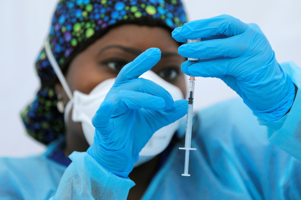 Registered Nurse Sheba Phillip prepares a syringe with a dose of the Pfizer-BioNTech vaccine for the coronavirus disease (COVID-19), during a vaccination event for local adolescents and adults outside the Bronx Writing Academy school in the Bronx borough of New York City, New York, U.S., June 4, 2021. REUTERS/Mike Segar