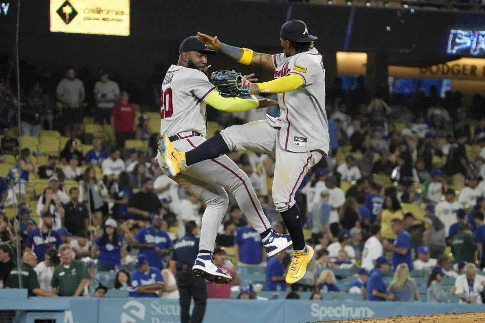 Atlanta Braves' Marcell Ozuna, left, and Ronald Acuna Jr. celebrate after the Braves defeated the Los Angeles Dodgers 6-3 in a baseball game Friday, Sept. 1, 2023, in Los Angeles. (AP Photo/Mark J. Terrill)