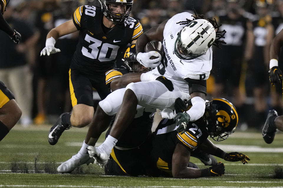 Michigan State tight end Maliq Carr (6) is tackled by Iowa defensive back Jermari Harris (27) after catching a pass during the first half of an NCAA college football game, Saturday, Sept. 30, 2023, in Iowa City, Iowa. (AP Photo/Charlie Neibergall)