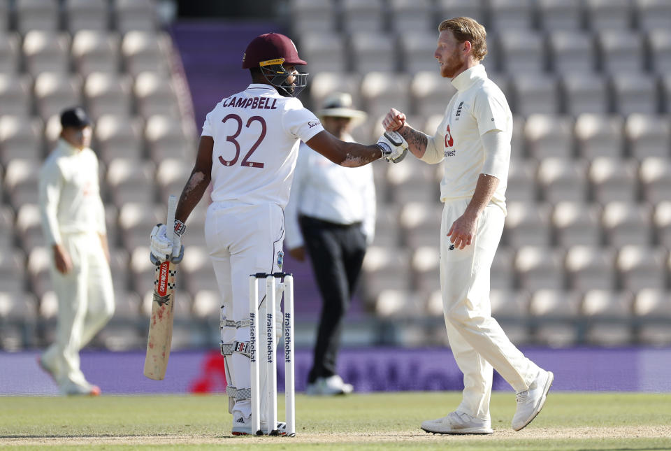 West Indies' John Campbell, left, greets England captain Ben Stokes after winning the first cricket Test match between England and West Indies, at the Ageas Bowl in Southampton, England, Sunday, July 12, 2020. (Adrian Dennis/Pool via AP)