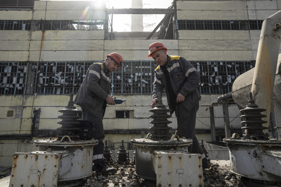 Workers check a transformer which was damaged by a Russian missile attack at DTEK's power plant in Ukraine, on Monday, April 1, 2024. Russia is attacking Ukraine’s energy sector with renewed intensity and alarming accuracy, signaling to Ukrainian officials that Russia is armed with better intelligence and fresh tactics in its campaign to annihilate the country’s power generation capacity. (AP Photo/Evgeniy Maloletka)