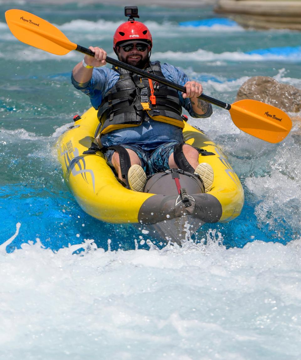 Chris Pecou rides his inflatable kayak Saturday during the grand opening weekend at Montgomery Whitewater.