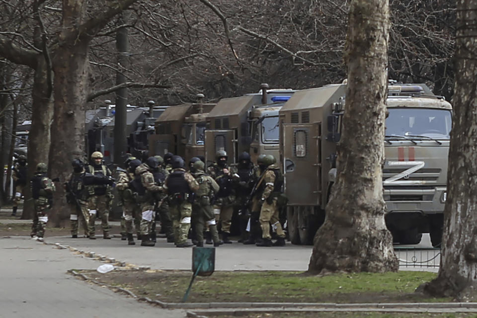 Russian army soldiers stand next to their trucks during a rally against Russian occupation in Svobody (Freedom) Square in Kherson, Ukraine, Monday, March 7, 2022. Ever since Russian forces took the southern Ukrainian city of Kherson in early March, residents sensed the occupiers had a special plan for their town. Now, amid a crescendo of warnings from Ukraine that Russia plans to stage a sham referendum to transform the territory into a pro-Moscow "people's republic," it appears locals guessed right. (AP Photo/Olexandr Chornyi)