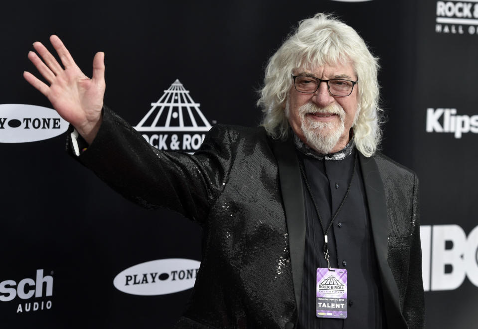 FILE - Graeme Edge, drummer for The Moody Blues, waves on the red carpet before the Rock & Roll Hall of Fame induction ceremony April 14, 2018, in Cleveland. Edge, a drummer and co-founder of the band, has died. He was 80. The band’s frontman, Justin Hayward, confirmed Edge’s death Thursday, Nov. 11, 2021, on the group’s website. The cause of his death has not been revealed. Hayward called Edge the backbone of the British rock band. The band's last album was released in 2003. (AP Photo/David Richard, File)