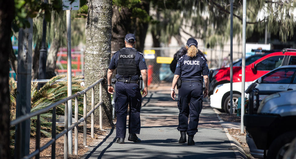 Police officers walk along the esplanade at Mooloolaba Beach in Mooloolaba, Australia.