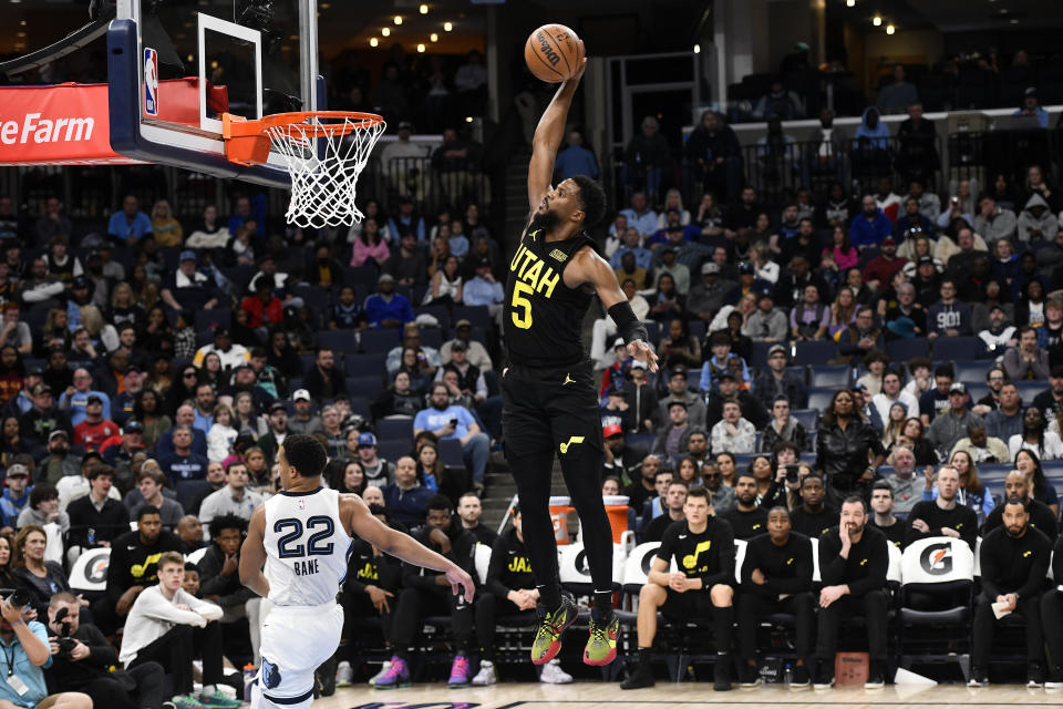 Utah Jazz guard Malik Beasley (5) goes up for a dunk ahead of Memphis Grizzlies guard Desmond Bane (22) in the second half of an NBA basketball game Sunday, Jan. 8, 2023, in Memphis, Tenn. (AP Photo/Brandon Dill)