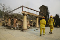 <p>A pair of Napa County firemen walk through the remains of the Signorello Estate Winery Tuesday, Oct. 10, 2017, in Napa, Calif. Worried California vintners surveyed the damage to their vineyards and wineries Tuesday after wildfires swept through several counties whose famous names have become synonymous with fine food and drink. (Photo: Eric Risberg/AP) </p>