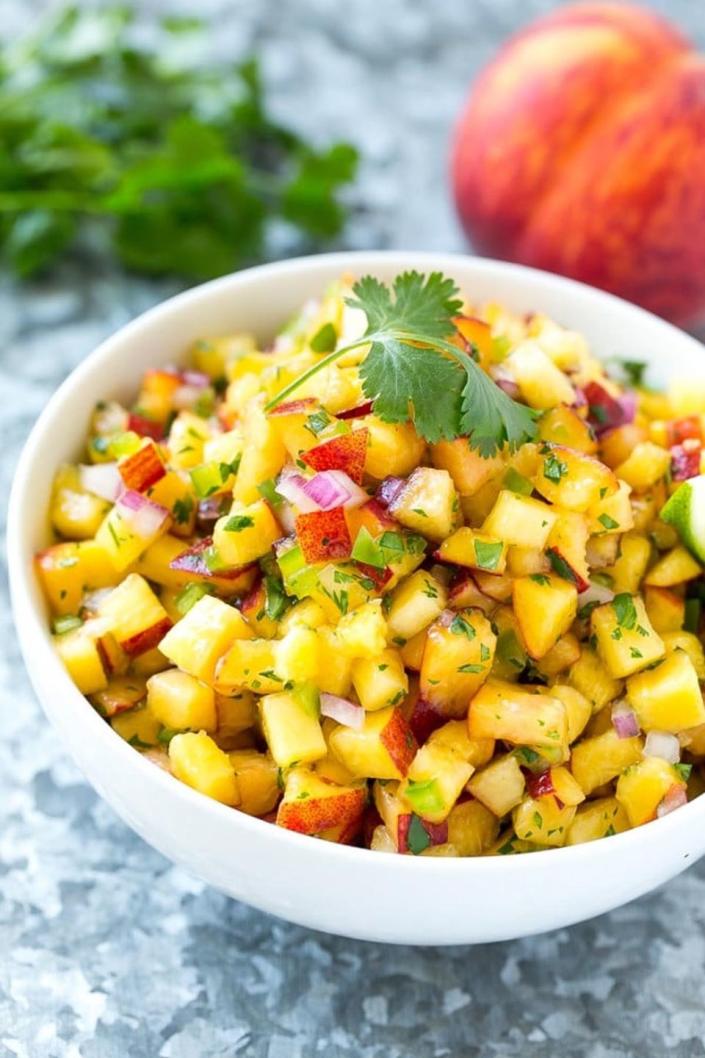 <p>Impress your barbecue guests with this sweet take on salsa.</p><p><strong>Get the recipe at <a href="http://www.dinneratthezoo.com/peach-salsa/" rel="nofollow noopener" target="_blank" data-ylk="slk:Dinner at the Zoo" class="link ">Dinner at the Zoo</a>.</strong></p>