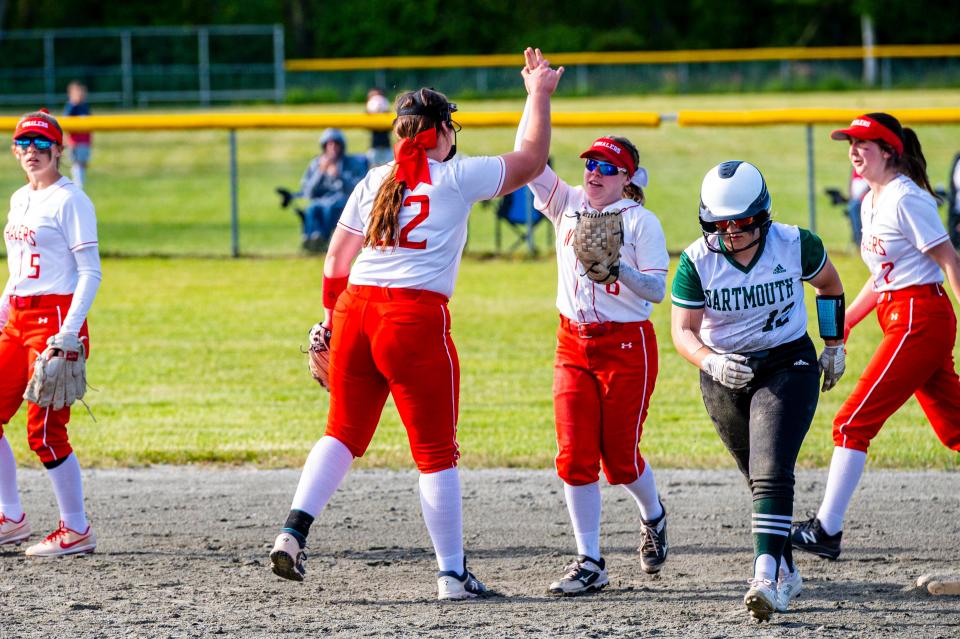 New Bedford's Lilly Gray high fives Abby Perry for her part in the inning ending double play.