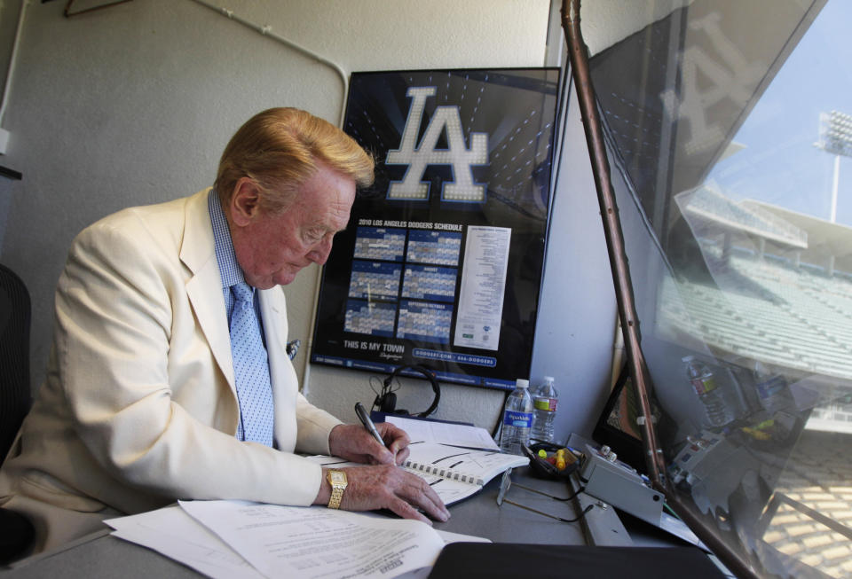 FILE - Vin Scully works in his booth at Dodger Stadium in Los Angeles on Aug. 22, 2010. Scully, whose dulcet tones provided the soundtrack of summer while entertaining and informing Dodgers fans in Brooklyn and Los Angeles for 67 years, died Tuesday night, Aug. 2, 2022, the team said. He was 94. (AP Photo/Jae C. Hong, File)