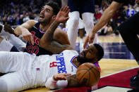 Los Angeles Clippers' Marcus Morris Sr., center, and Philadelphia 76ers' Georges Niang react after Morris went out of bounds during the final seconds of an NBA basketball game, Friday, Jan. 21, 2022, in Philadelphia. (AP Photo/Matt Slocum)