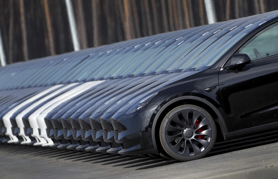 File - Tesla cars are parked at the construction site of the new Tesla Gigafactory for electric cars in Gruenheide near Berlin, Germany, March 18, 2022. Tesla is expected to report fourth quarter and full year sales Tuesday as electric vehicle sales growth continues to slow. (AP Photo/Michael Sohn, File)