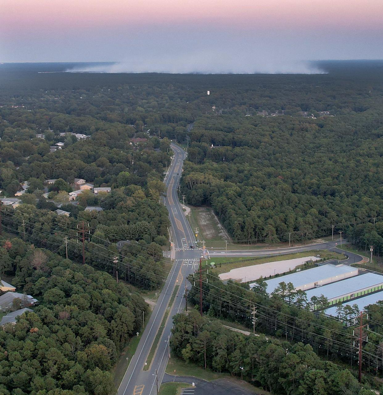 Smoke rises from the Airpark Wildfire in Lacey Township shown in this view looking east along Lacey Road from Manchester Sunday, September 3, 2023.