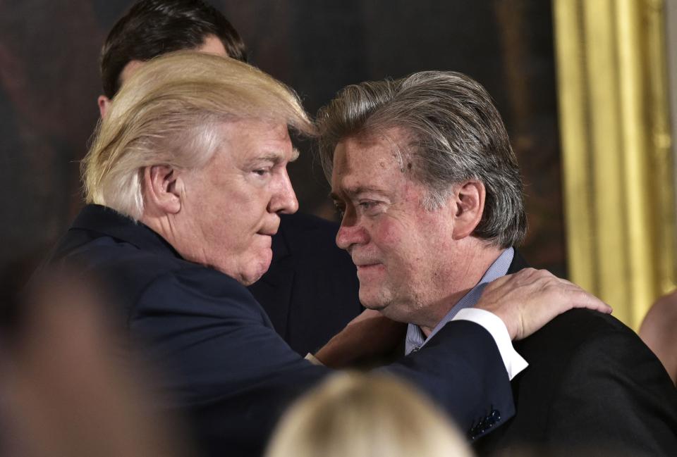 (FILES) In this file photo taken on January 22, 2017 US President Donald Trump (L) congratulates Senior Counselor to the President Stephen Bannon during the swearing-in of senior staff in the East Room of the White House in Washington, DC. - Lawmakers investigating the deadly assault on the US Capitol said Thursday they were pursuing criminal contempt charges for a key ally of former president Donald Trump for refusing to testify.Former White House advisor Steve Bannon had already made clear he had no intention of complying with a subpoena to appear Thursday before the cross-party January 6 congressional select committee. (Photo by MANDEL NGAN / AFP) (Photo by MANDEL NGAN/AFP via Getty Images) ORG XMIT: 0 ORIG FILE ID: AFP_9PP7DL.jpg