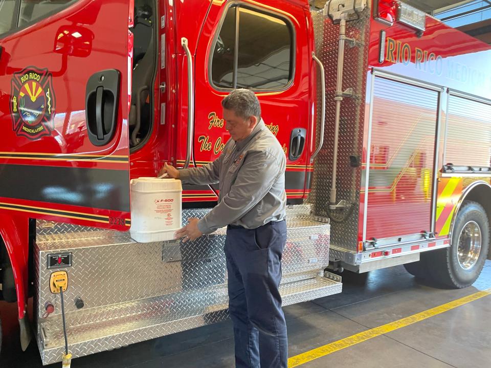 Frank Granados, a Rio Rico fire senior advisor, shows the replacement product for PFAS-laced firefighting foam. Granados, who lost colleagues to cancer, spearheaded efforts to ditch the old foam three years ago.