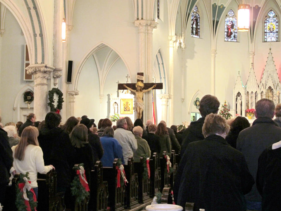This Jan. 12, 2014 photo shows people gathered for mass inside Our Lady of Perpetual Help Church in Buffalo, N.Y., during a “Mass Mob.” Borrowed from the idea of flash mobs, Mass Mobs encourage crowds to attend Mass at a specified church on a certain day to fill pews, lift spirits and help financially some of the city’s oldest but often sparsely attended churches. (AP Photo/Carolyn Thompson)