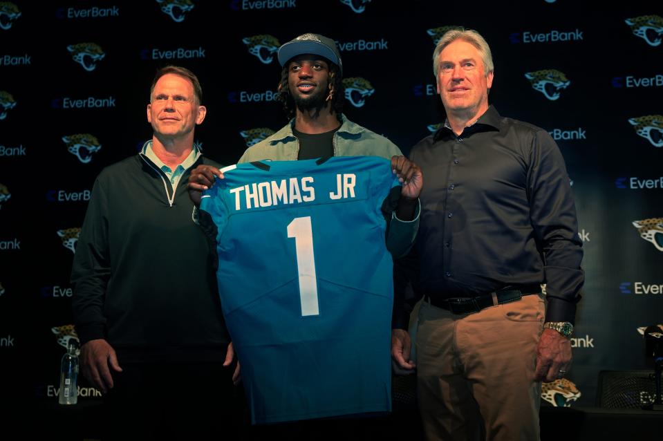 Jacksonville Jaguars' first-round draft pick Brian Thomas Jr., seen here at his introductory press conference with GM Trent Baalke and head coach Doug Pederson, has the makeup and skill set to break the team's rookie receiving records.
