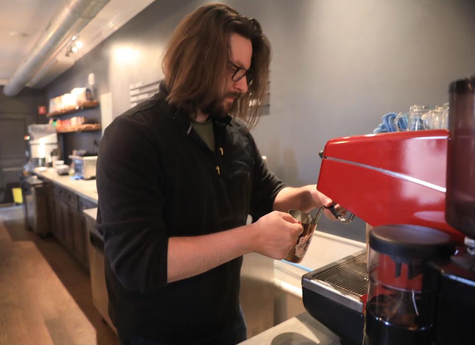 Mercat by 1915 barista Matt Patane prepares a cafe latte  on April 12, 2022.  Mercat by 1915 is the coffee shop, cafe and market inside 40 Cannon Street in the City of Poughkeepsie. 