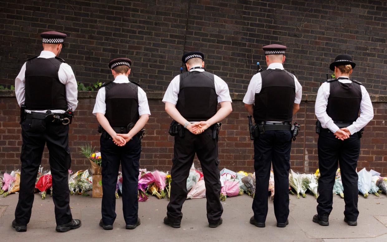 Met Police officers laying flowers
