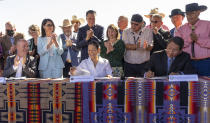 Utah Gov. Spencer J. Cox, left, U.S. Secretary of the Interior Deb Haaland, middle, and Jonathan Nez, president of the Navajo Nation gather with local officials as they sign the agreement for the Navajo federal reserved water rights settlement Friday, May 27, 2022 in Monument Valley, Utah. (Rick Egan/The Salt Lake Tribune via AP)