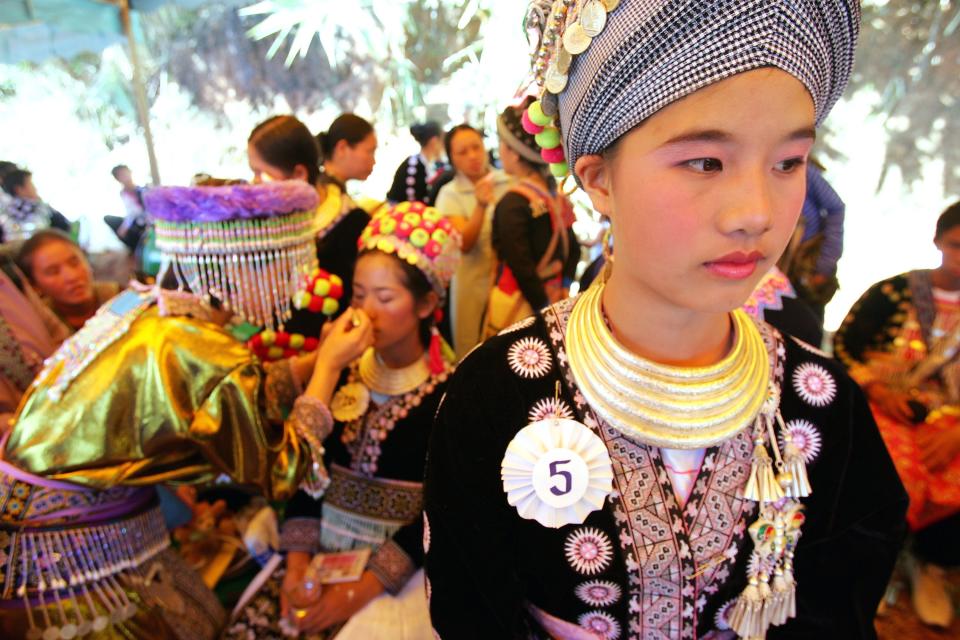 Contestants in a beauty pageant wait backstage during Hmong New Year celebrations Tuesday, Jan. 3, 2006, in Nong Hoi Mai village, north of Chiang Mai, Thailand. The Hmong, who trace their roots back to China, have large populations in Thailand, Myanmar, and Laos. (AP Photo/David Longstreath)