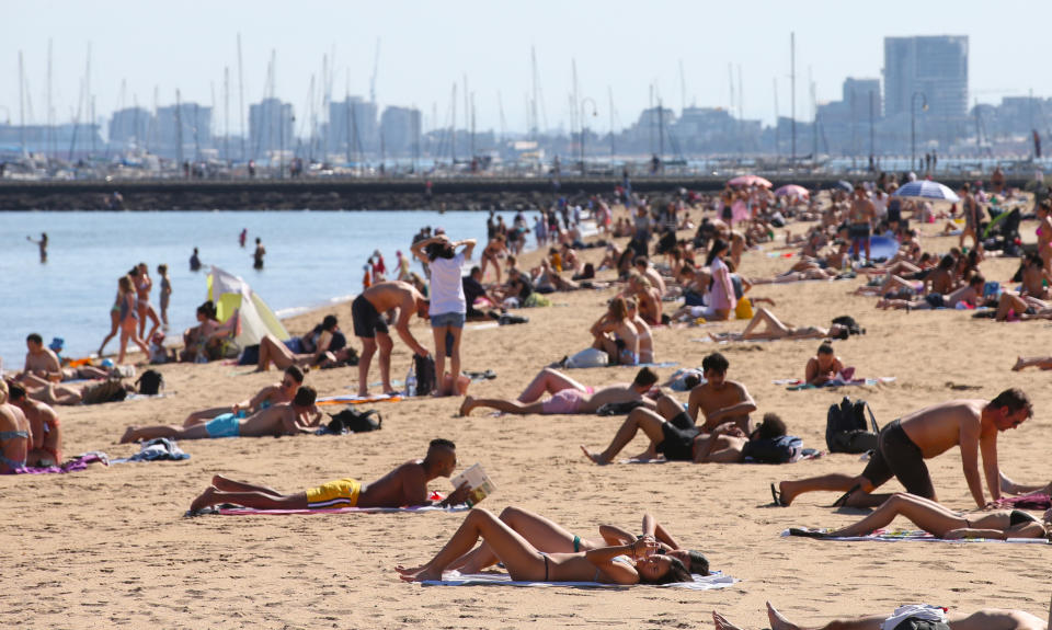 People laying in the sun on St Kilda Beach in Melbourne as 50 degree days predicted for Australia.